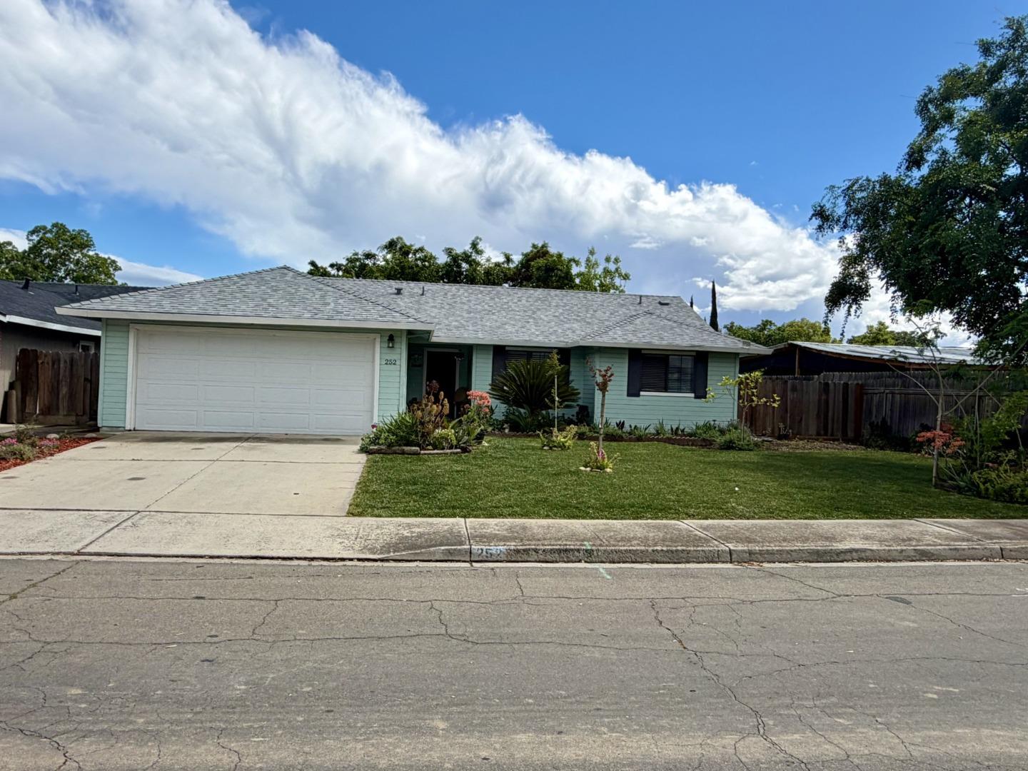 a front view of house with yard and green space