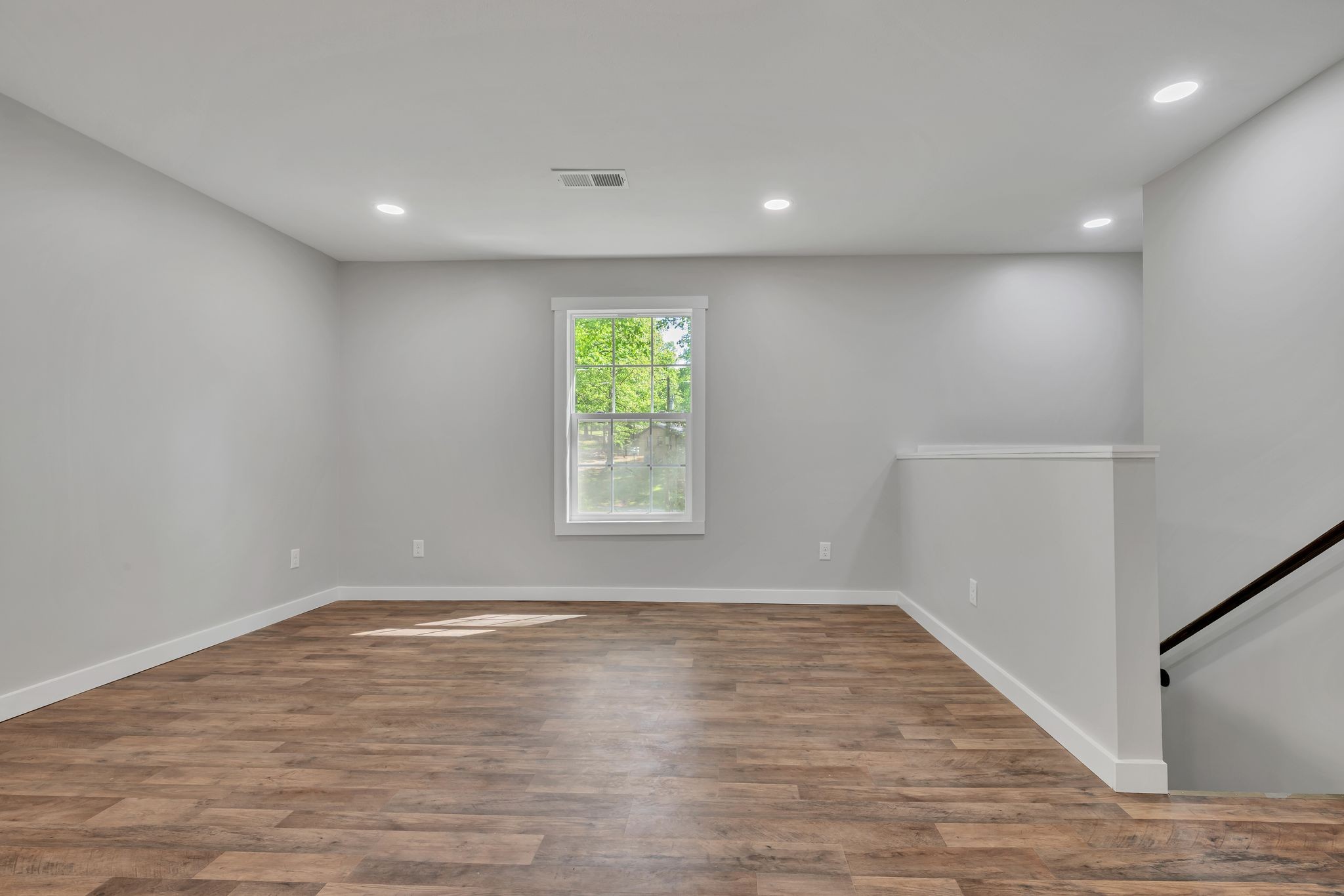 120 Bern Street Waverly, TN 37185 - Photo 11 of 36 an empty room with wooden floor and windows