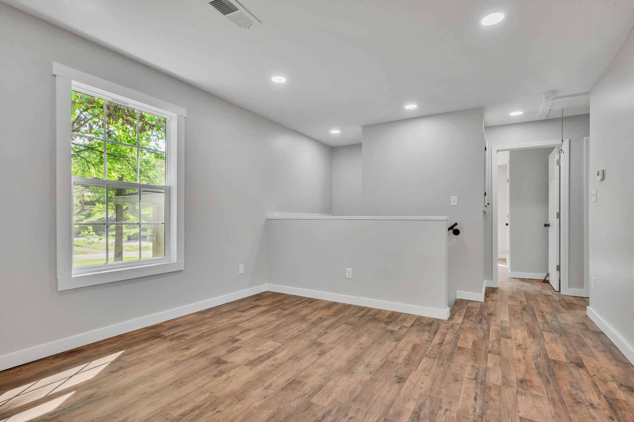 120 Bern Street Waverly, TN 37185 - Photo 13 of 36 an empty room with wooden floor and windows