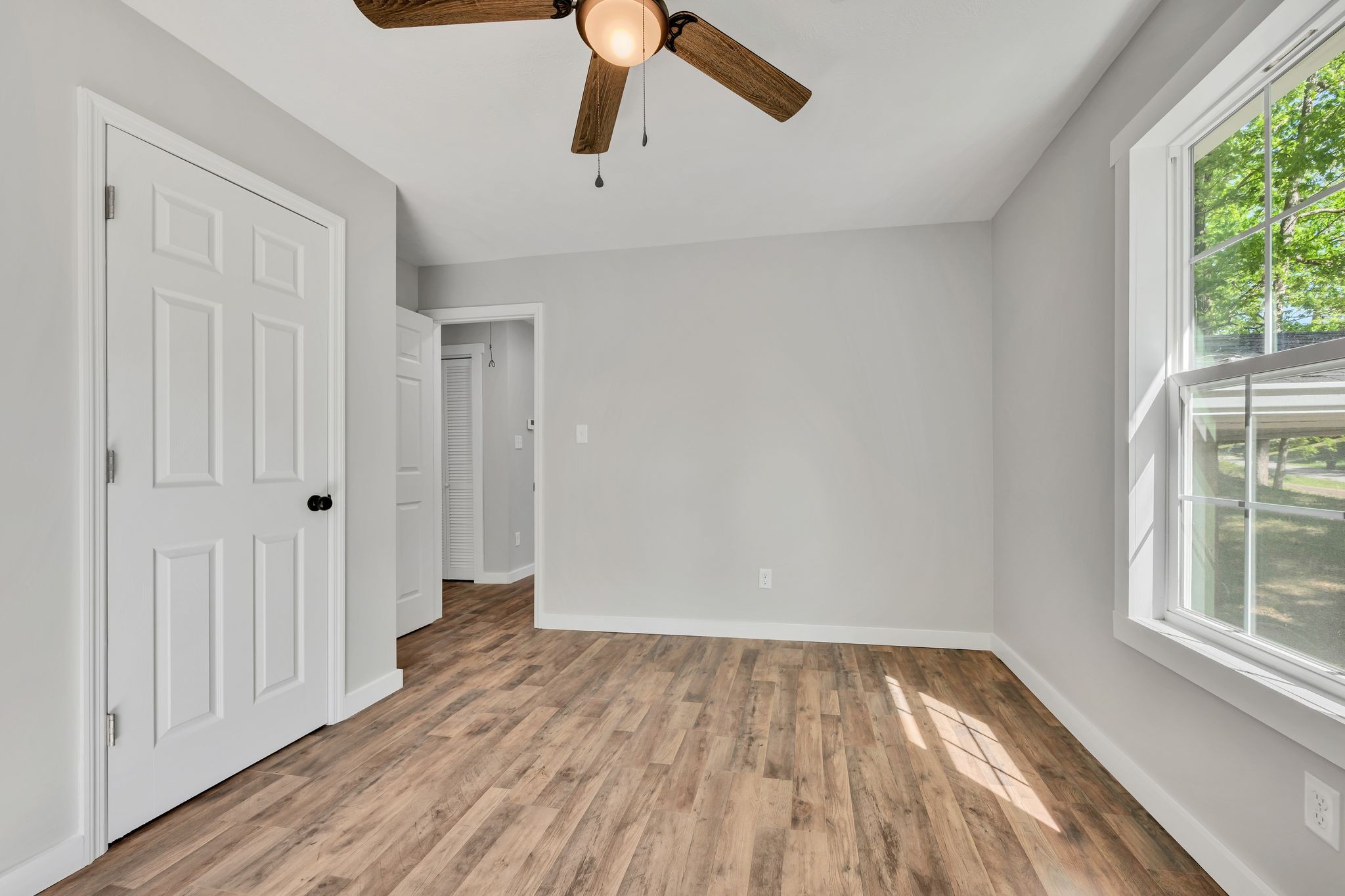 120 Bern Street Waverly, TN 37185 - Photo 19 of 36 a view of empty room with wooden floor and window