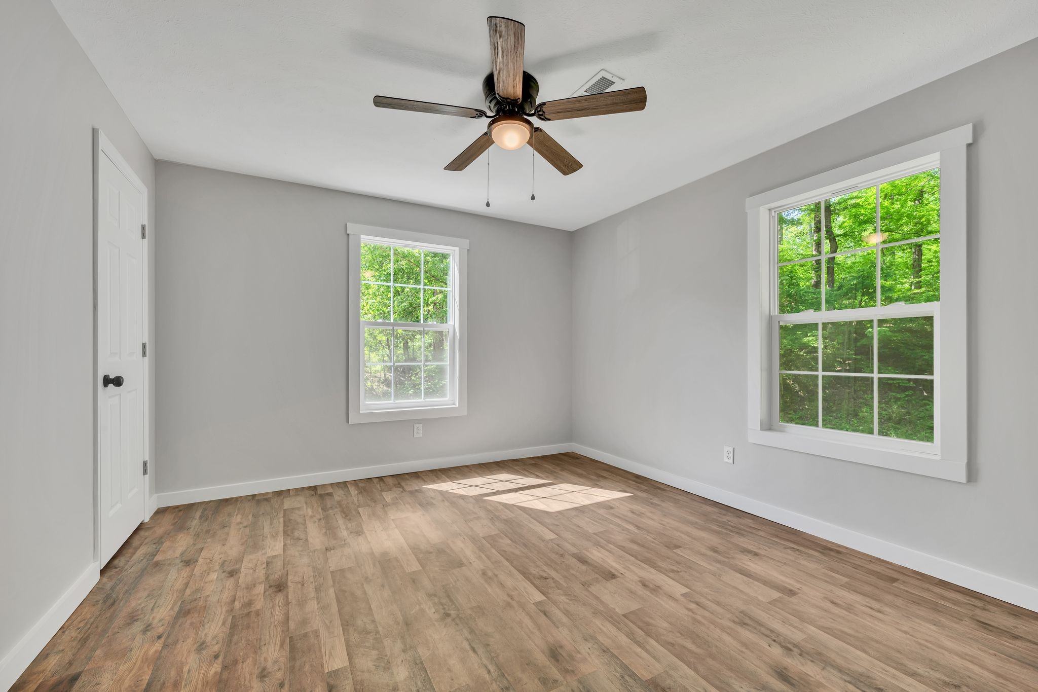 120 Bern Street Waverly, TN 37185 - Photo 20 of 36 a view of empty room with wooden floor and fan