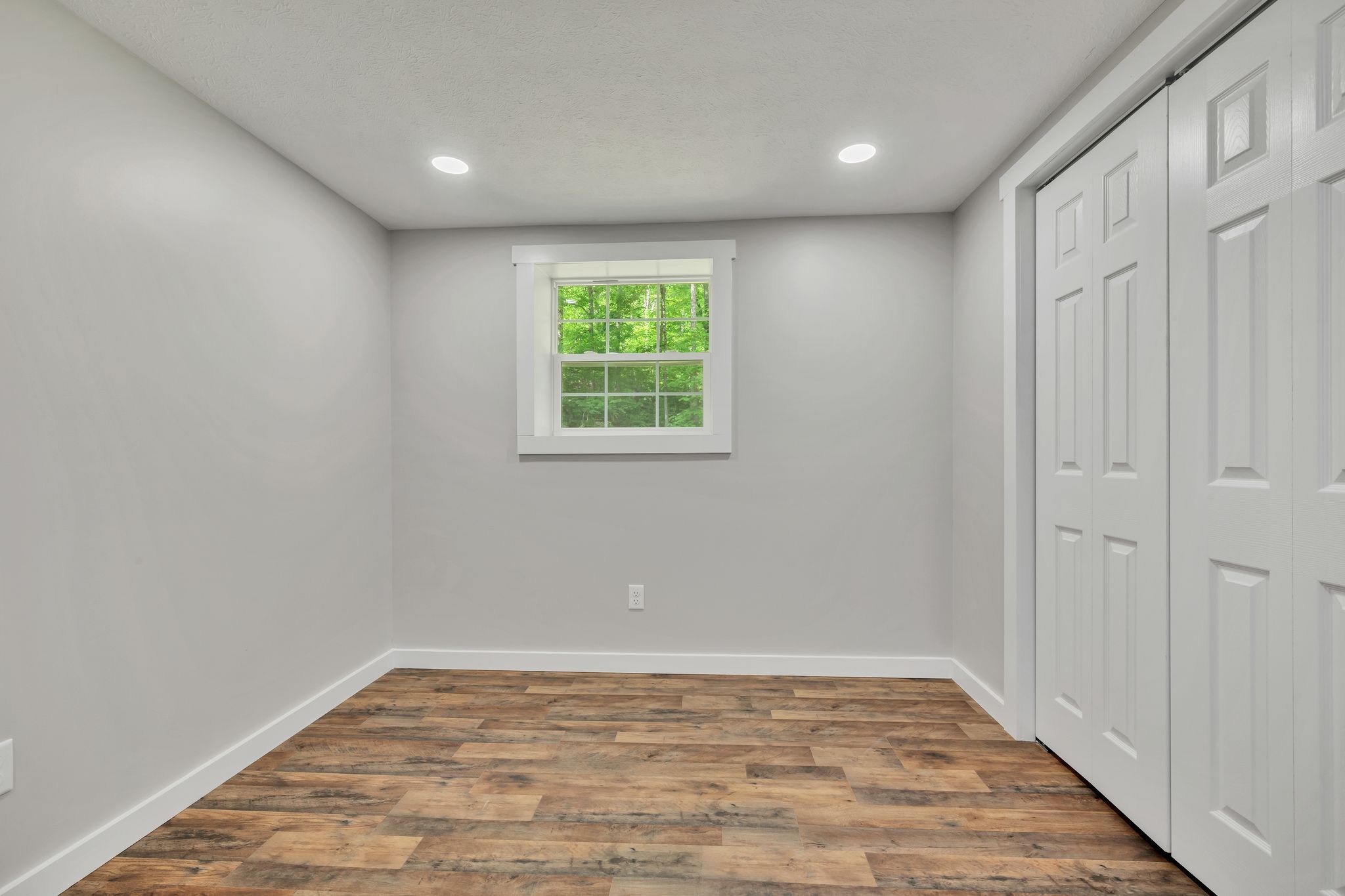 120 Bern Street Waverly, TN 37185 - Photo 26 of 36 an empty room with wooden floor and windows