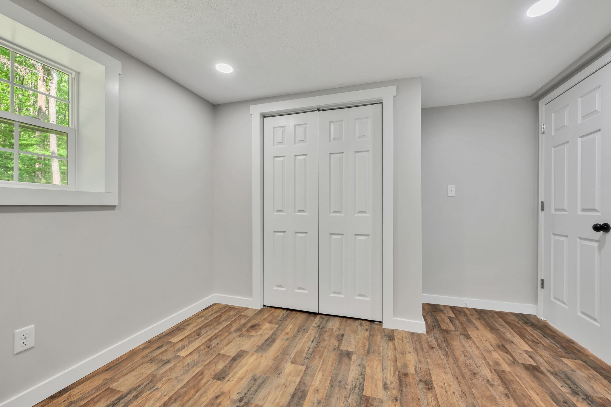 120 Bern Street Waverly, TN 37185 - Photo 27 of 36 a view of an empty room with wooden floor and a window