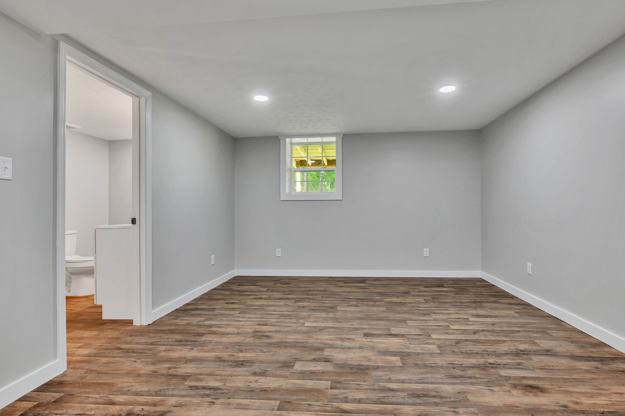120 Bern Street Waverly, TN 37185 - Photo 28 of 36 an empty room with wooden floor and windows