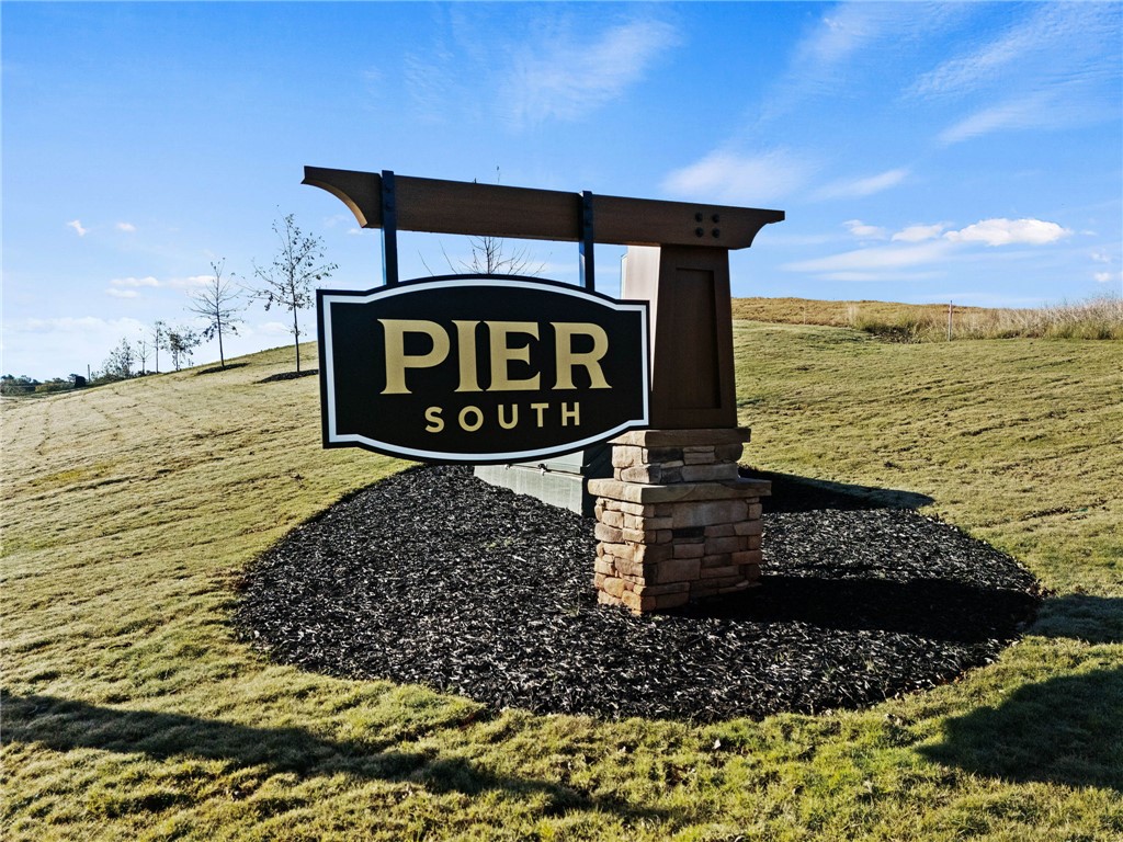 557 Hydrangea Street, Unit LOT 46 Seneca, SC 29678 - Photo 35 of 37 Discover the impressive entrance sign to Pier South, gracefully nestled on a well-maintained grassy knoll.