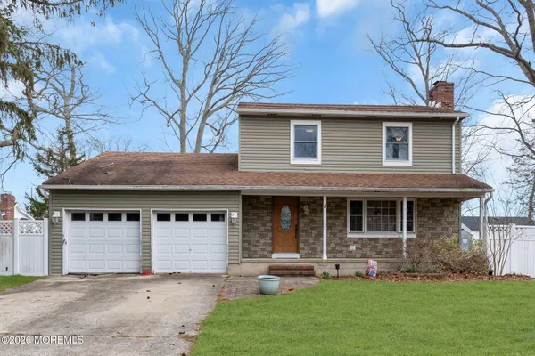 a front view of a house with a garden and yard