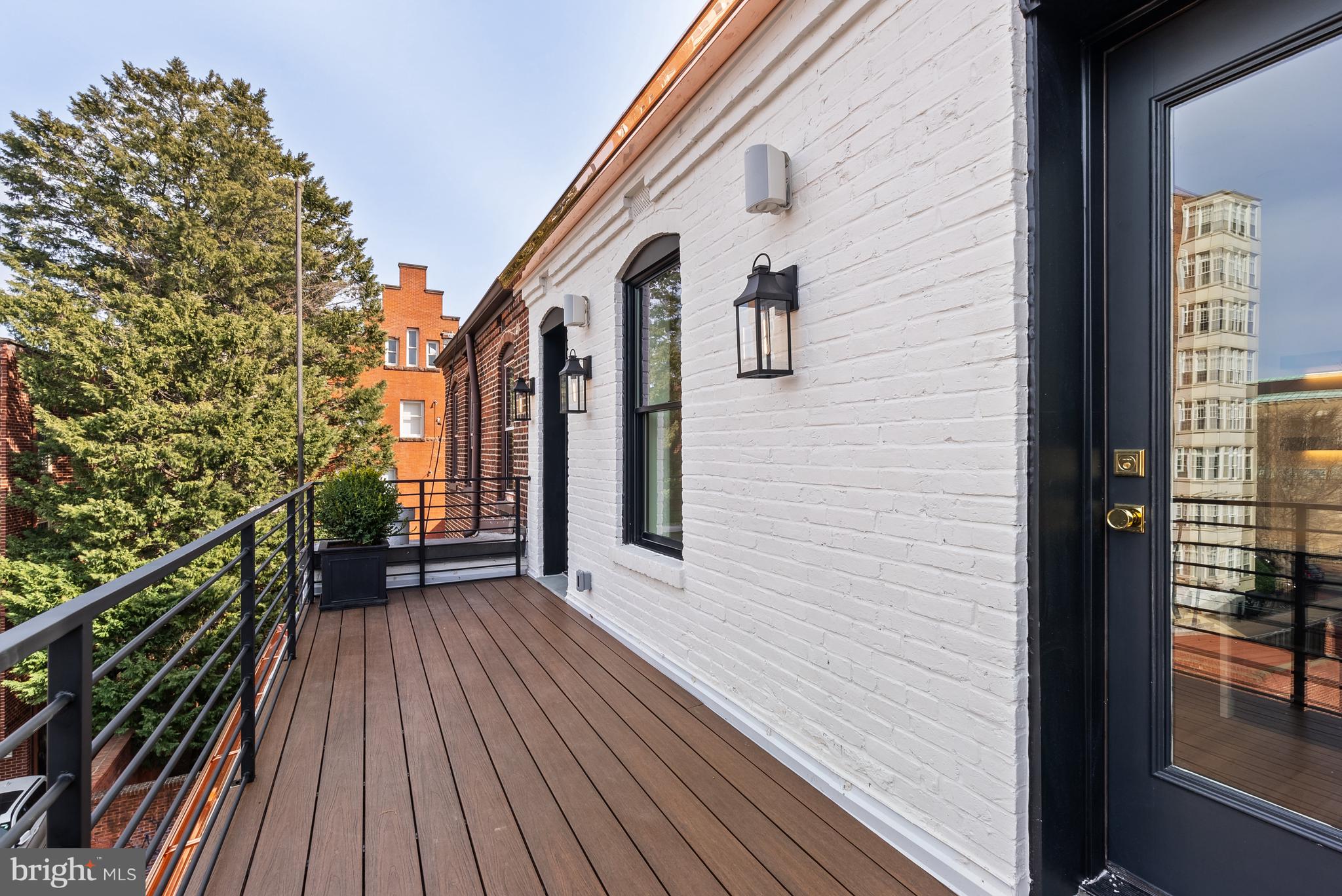 1611 Riggs Place Northwest Washington, DC 20009 - Photo 30 of 56 a view of a house with a wooden deck