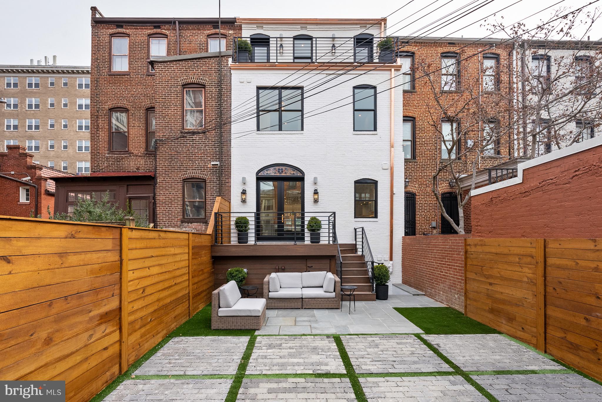 1611 Riggs Place Northwest Washington, DC 20009 - Photo 52 of 56 a view of a brick house with many windows