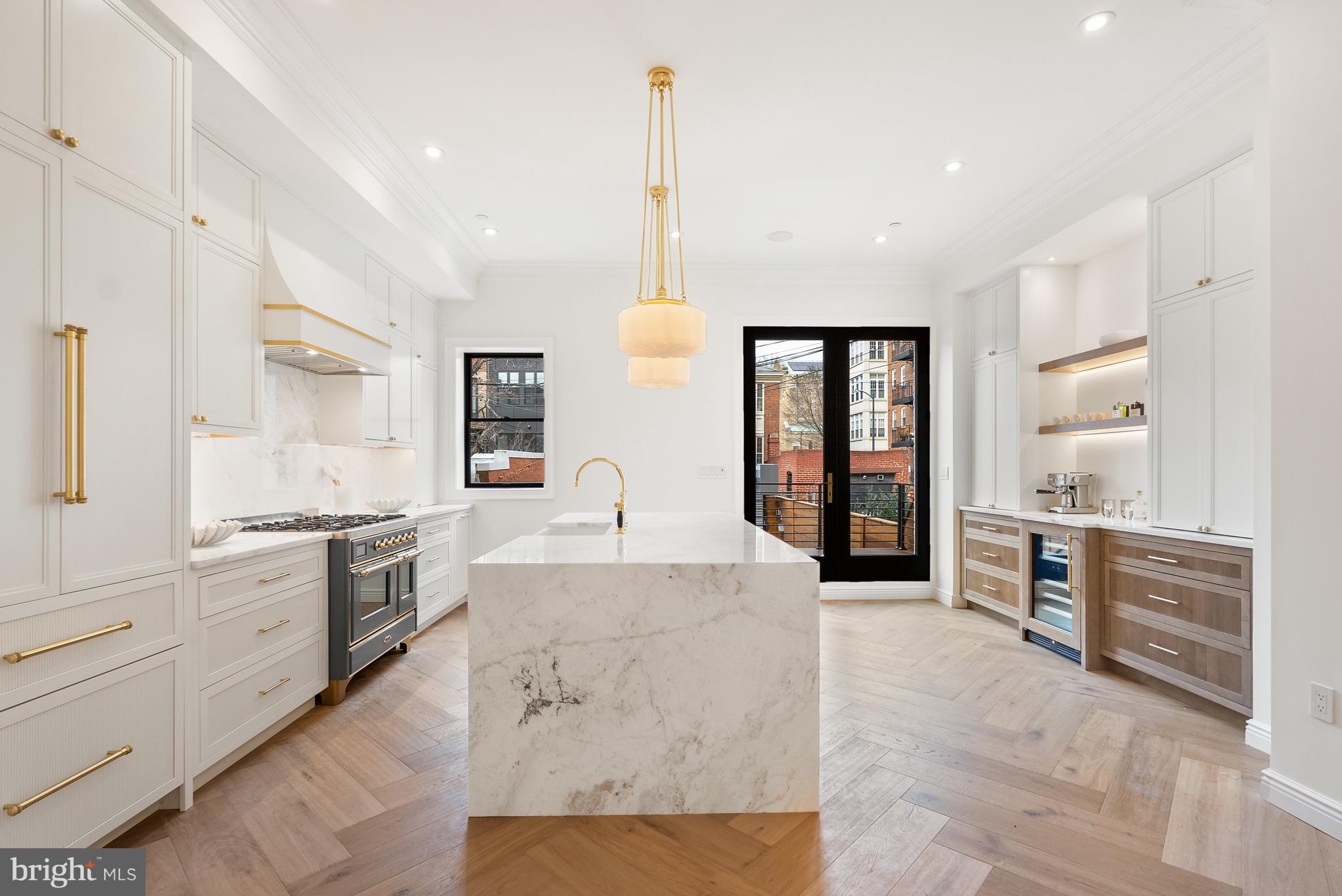 1611 Riggs Place Northwest Washington, DC 20009 - Photo 7 of 56 a large kitchen with kitchen island granite countertop a large counter top and sink