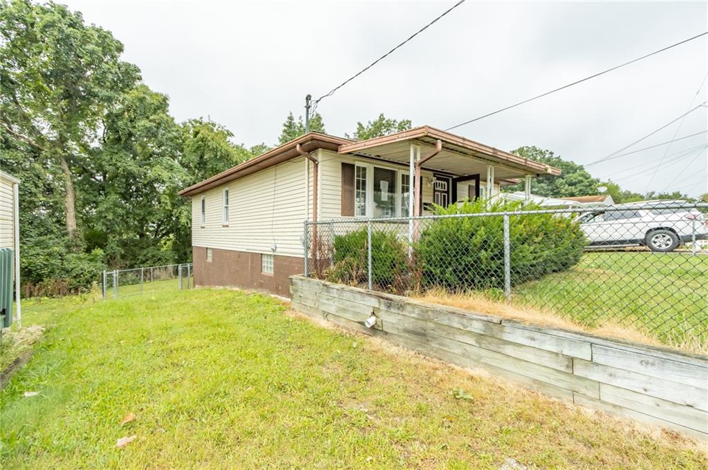 a yellow house with trees in the background