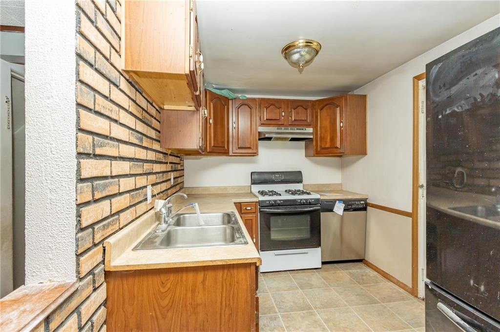 406 Violet Drive Lower Burrell, PA 15068 - Photo 7 of 15 a kitchen with a sink stove and refrigerator