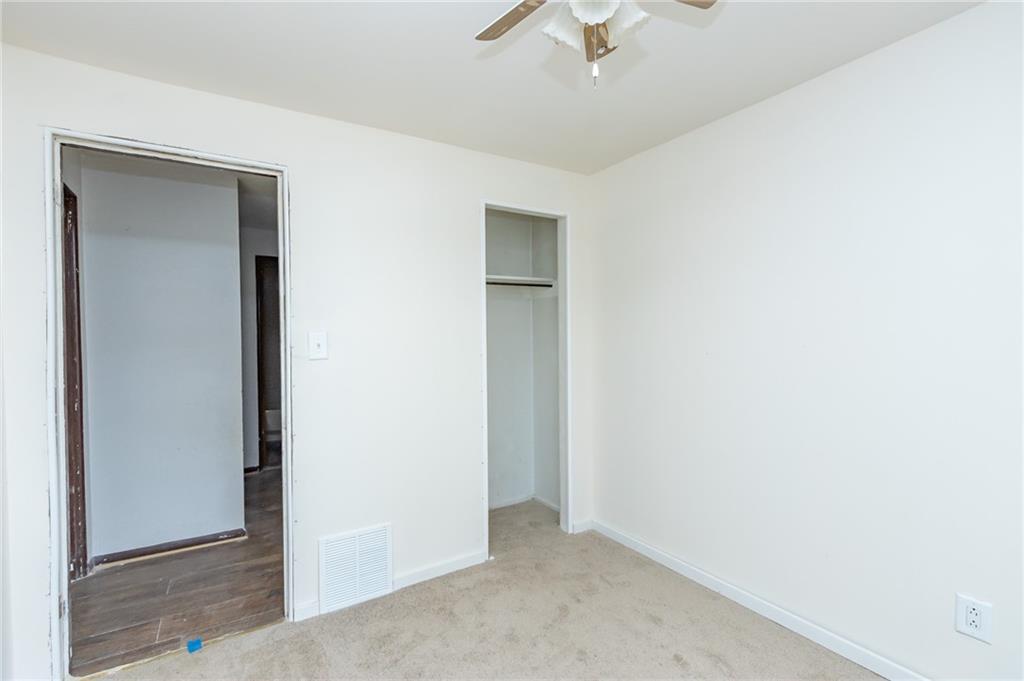406 Violet Drive Lower Burrell, PA 15068 - Photo 9 of 15 an empty room with a hallway and chandelier fan