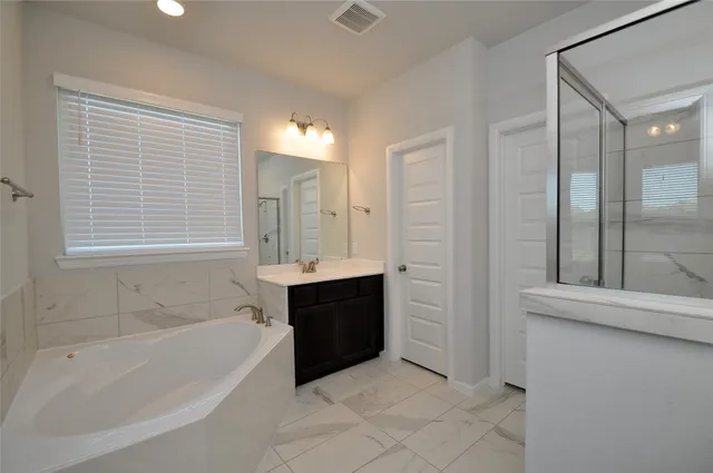 a bathroom with a bathtub and a sink