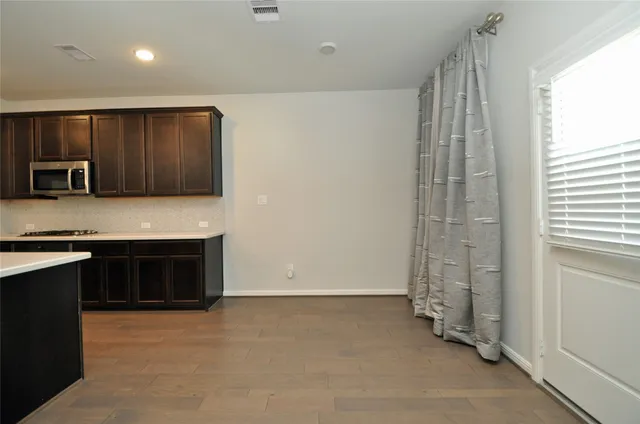 a view of a dining room with furniture window and flowerpot