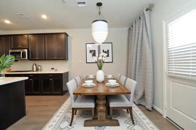 a kitchen with a table chairs and a window
