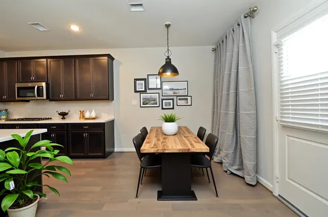 a living room with patio furniture and a potted plants