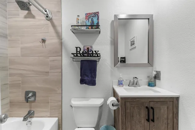 a bathroom with a sink toilet and mirror