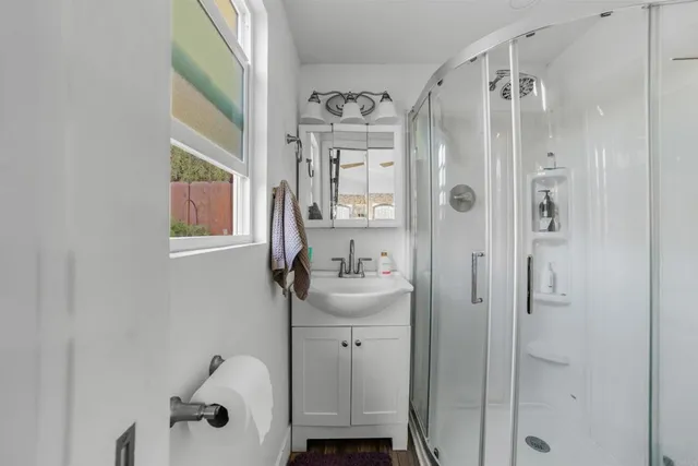 a bathroom with a sink a mirror and a shower