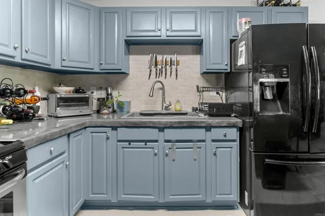 a kitchen with stainless steel appliances granite countertop a refrigerator and stove