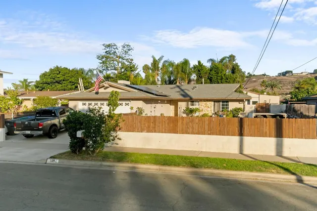 a view of a street with a car parked on the road