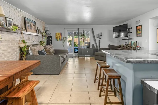 a large living room with stainless steel appliances granite countertop a couch and a view of living room