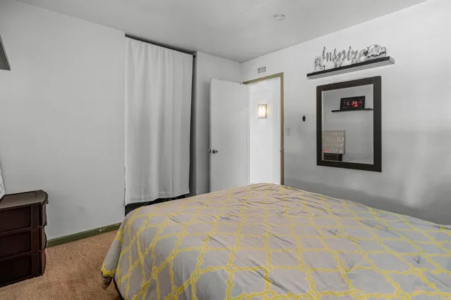 a bedroom with a bed and a mirror