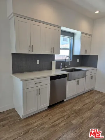 a kitchen with stainless steel appliances granite countertop a sink and a stove