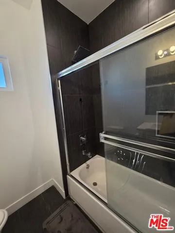 a bathroom with a tub and sink