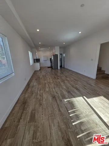 a view of a kitchen with wooden floor