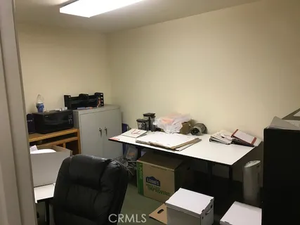 a bed room with a bed a dresser and a window