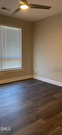 a view of a room with wooden floor and window