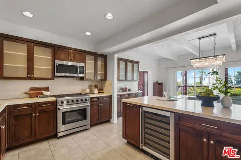 a kitchen with stainless steel appliances granite countertop a stove sink and microwave
