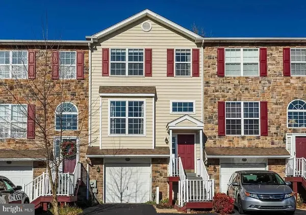 a front view of a house with parking space