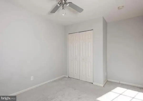 an empty room with a empty space and a ceiling fan