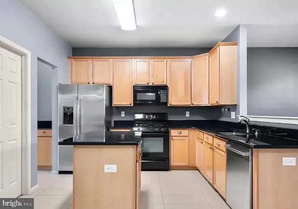 a kitchen with stainless steel appliances granite countertop a stove a refrigerator a sink and dishwasher