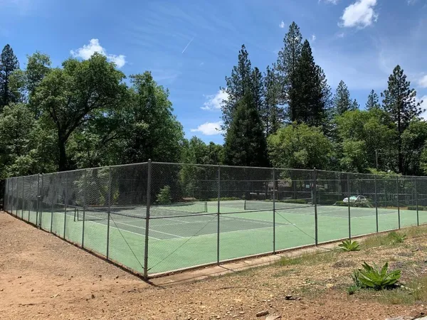 a view of a backyard with fence