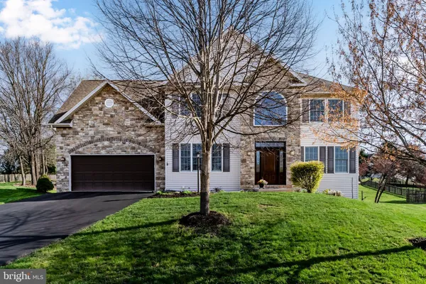 a front view of house with a garden