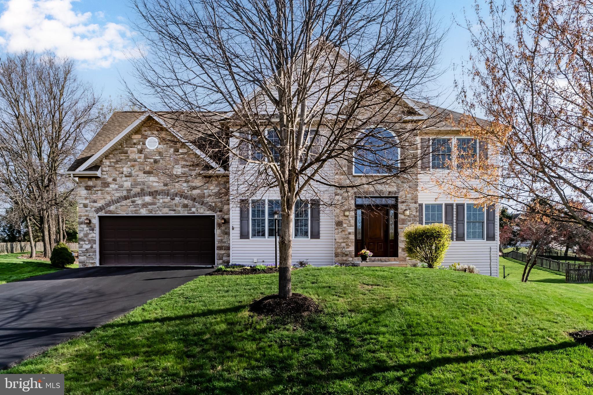 a front view of house with a garden