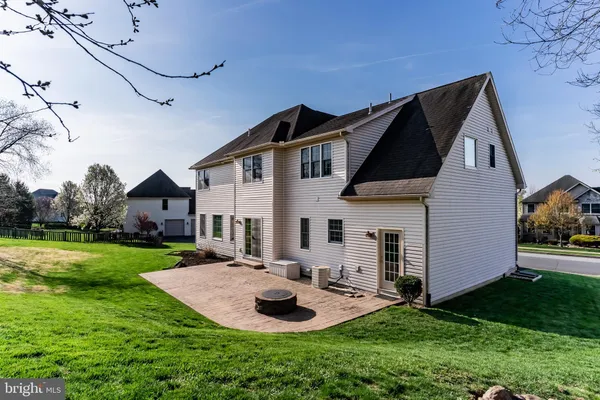 a front view of house with yard and green space