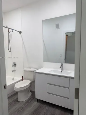 a bathroom with a toilet sink and shower