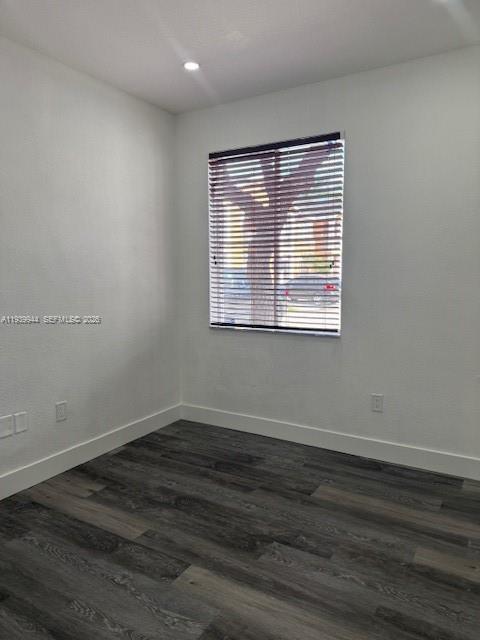 17820 Northwest 73rd Avenue, Unit 1011 Hialeah, FL 33015 - Photo 5 of 11 a view of an empty room with wooden floor and a window