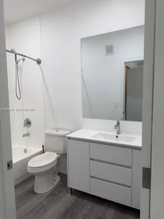 a bathroom with a toilet sink and shower