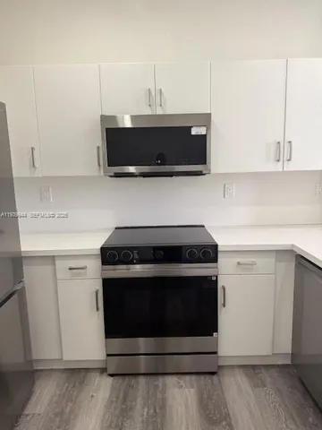 a stove top oven sitting inside of a kitchen