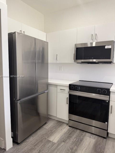 17820 Northwest 73rd Avenue, Unit 1011 Hialeah, FL 33015 - Photo 8 of 11 a kitchen with a stove and a refrigerator