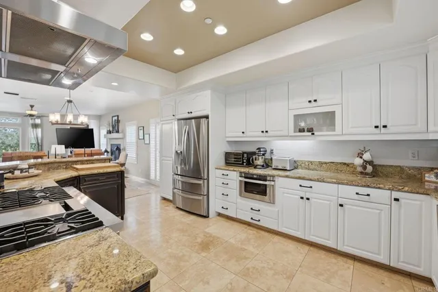 a bathroom with a granite countertop toilet sink and a mirror