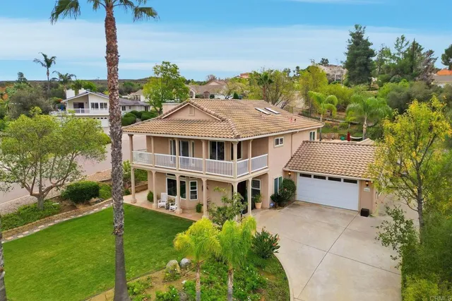 a aerial view of a house with a yard and potted plants