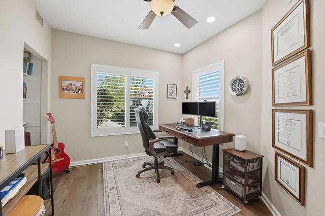a bedroom with a bed a book shelf and a window