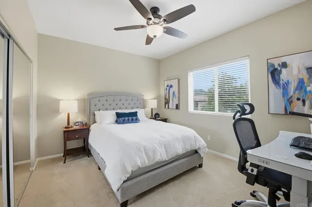 a bedroom with a large bed chandelier and a window