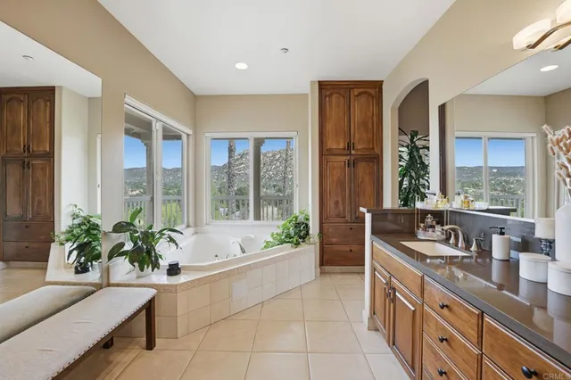 a view of a dining tables and chairs in a patio with a garden
