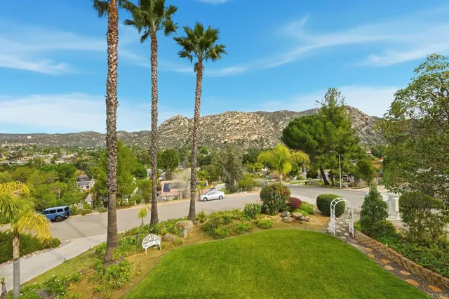 a view of a swimming pool with a yard and sitting area